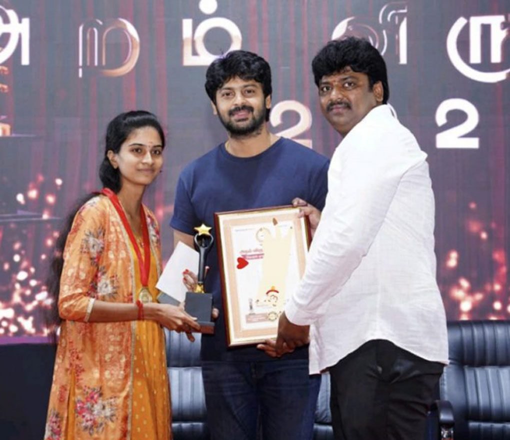 Founder receiving an award on stage at a public ceremony