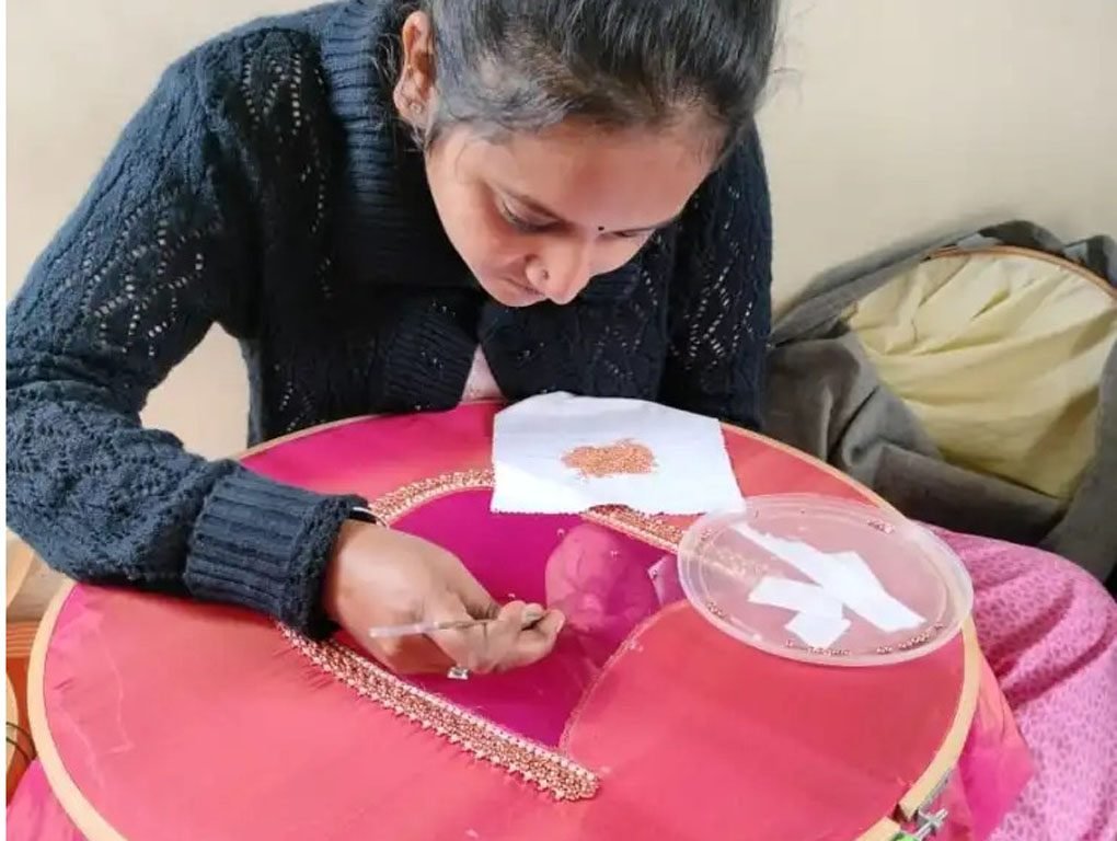 Student displaying finished Aari embroidery work