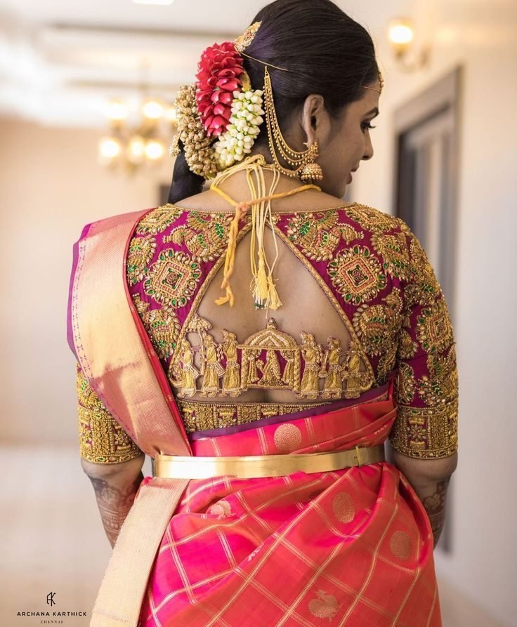 Bride wearing a heavily embroidered pink and gold blouse