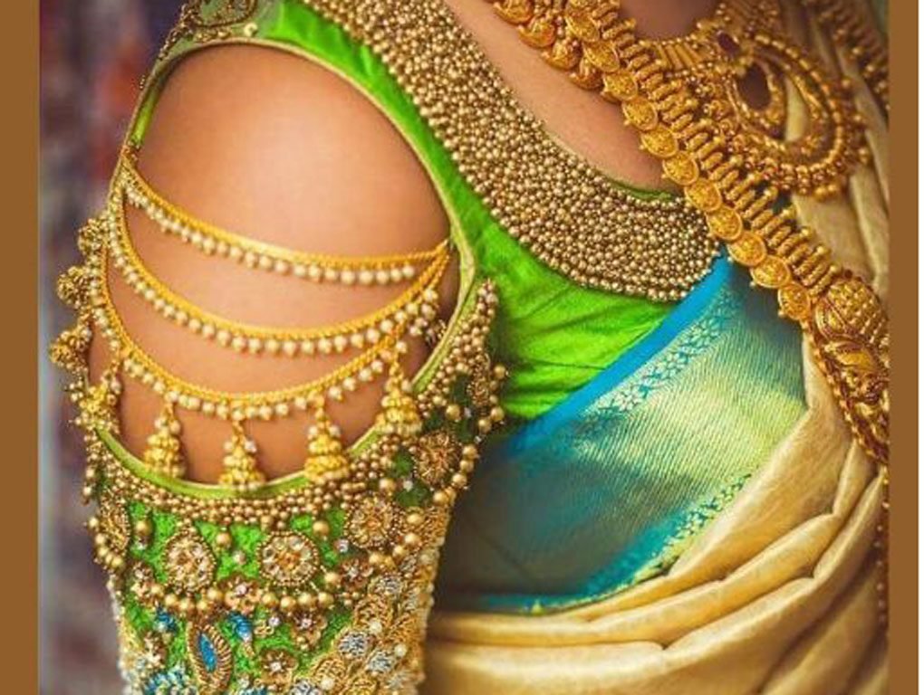 Close up of blue and green embroidered blouse shoulder